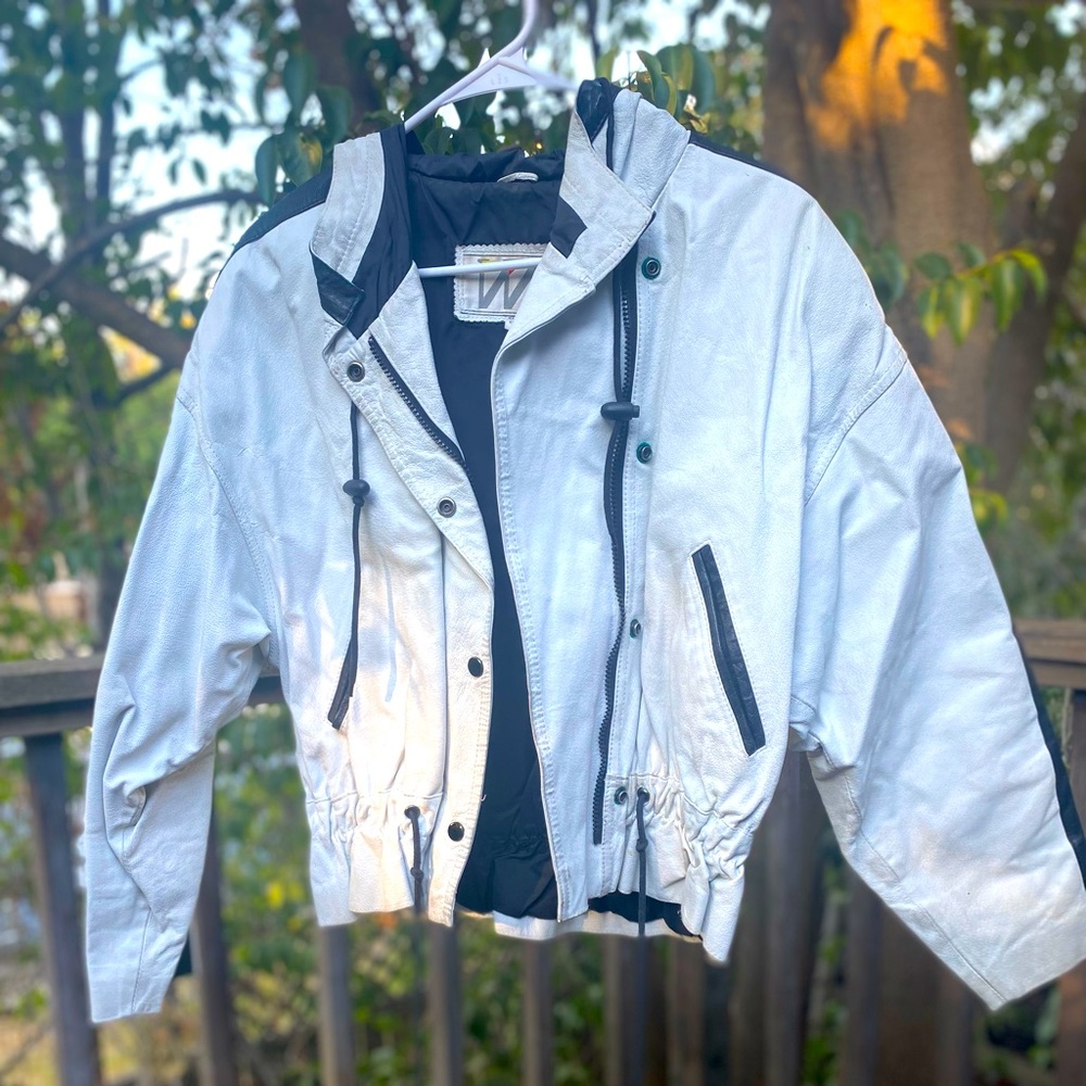 Wilson’s white leather coat with black stripe, lightly worn.